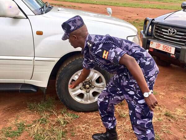 Police Officer Deflates Besigye Car